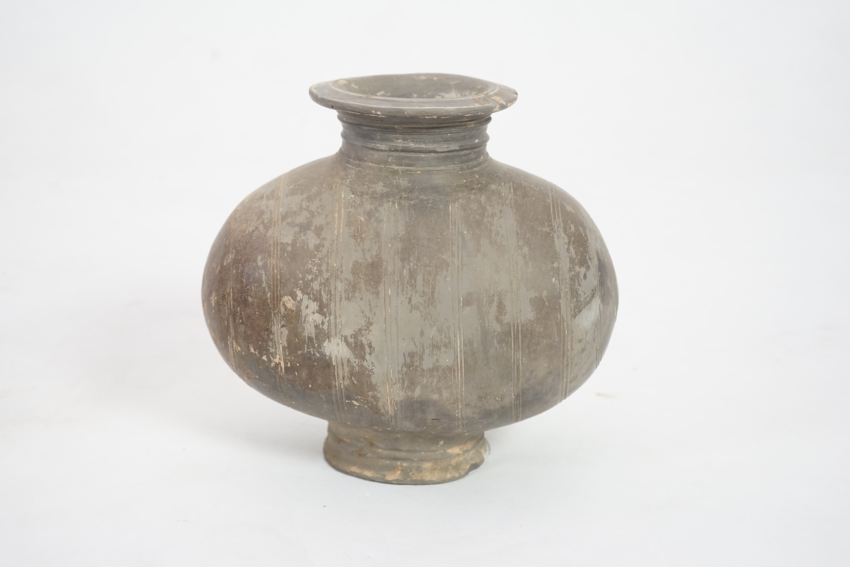 A Chinese incised and burnished pottery cocoon jar, Western Han Dynasty (206 BC-AD 8)